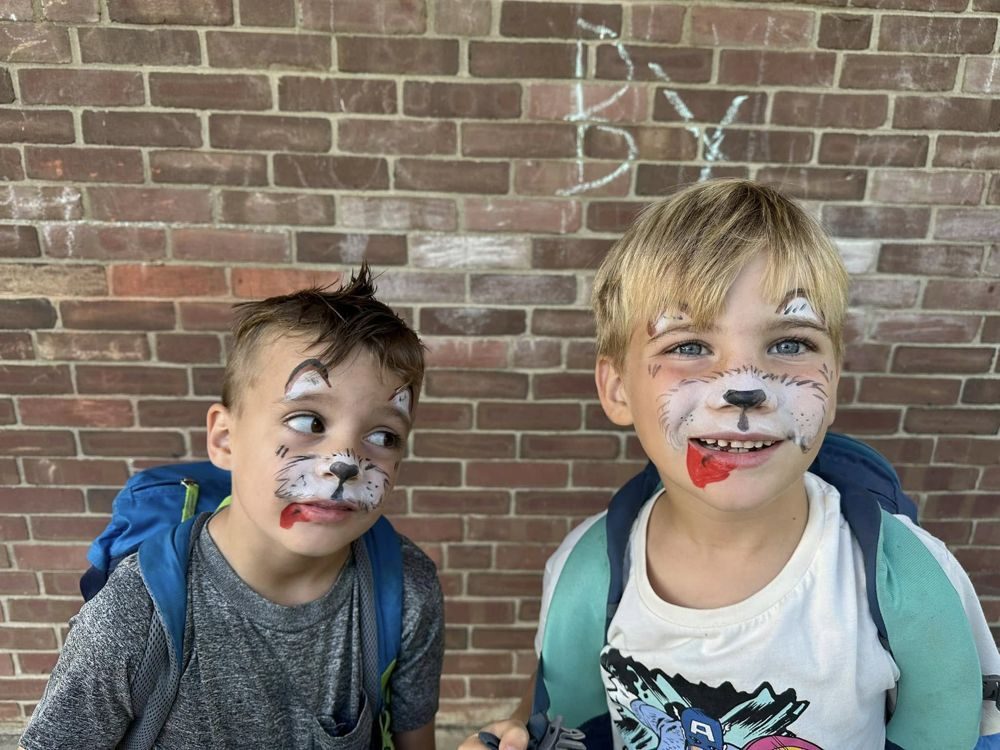 Two boys with painted puppy faces
