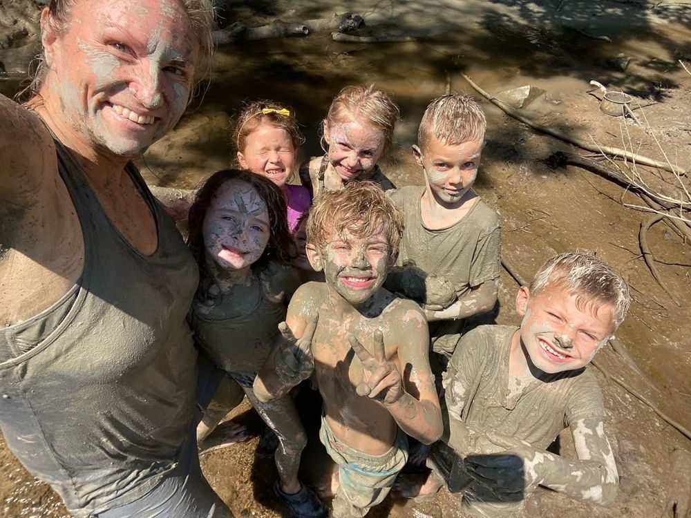 Mud-covered kids and Dawn grinning